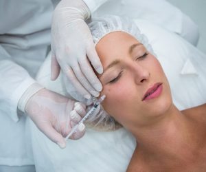 Close-up of female patient receiving a botox injection on face