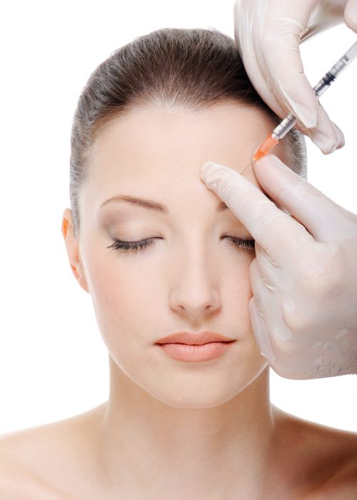 giving an injection in the eyebrow on the female face - white background